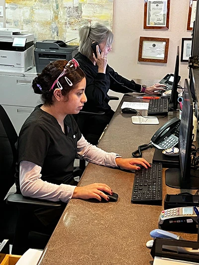 front office staff hard at work answering dental insurance and financing questions